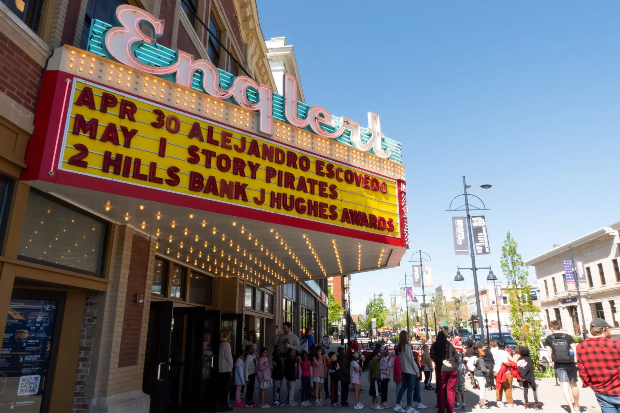 marquee of the englert on a clear day with children coming to see Story Pirates